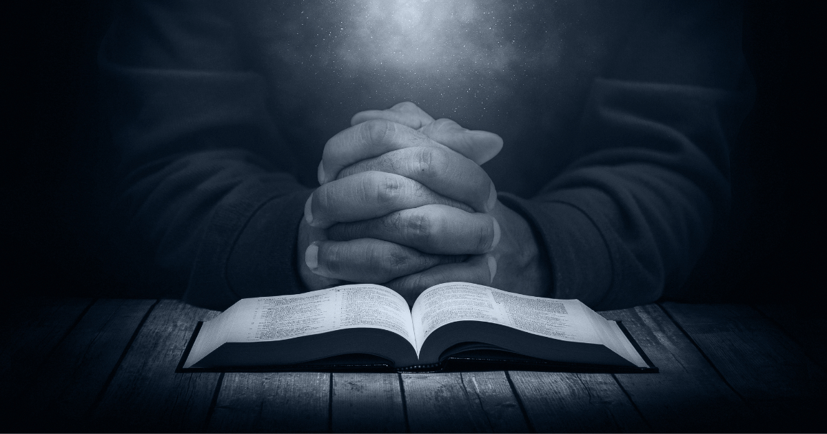 open bible with person reading