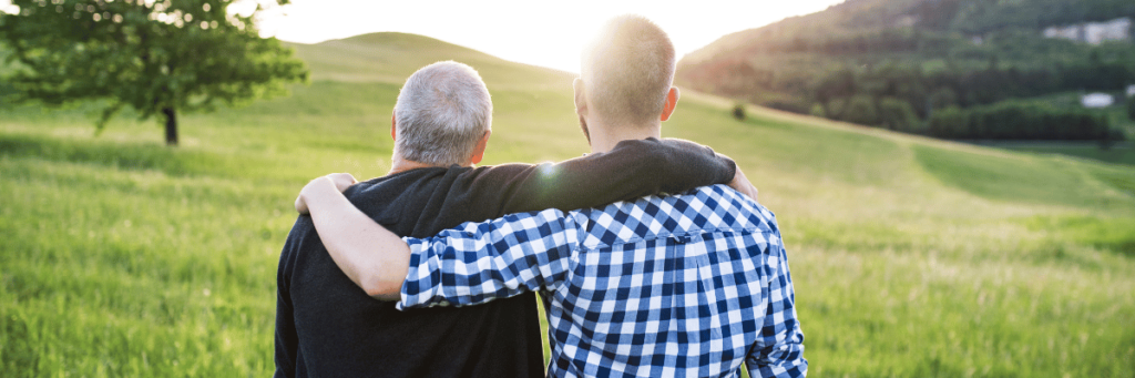 fathers arm around son being positive role model