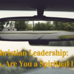 Rearview mirror reflects the image of a church building. An article title "Christian Leadership: Husbands, Are You a Spiritual Leader