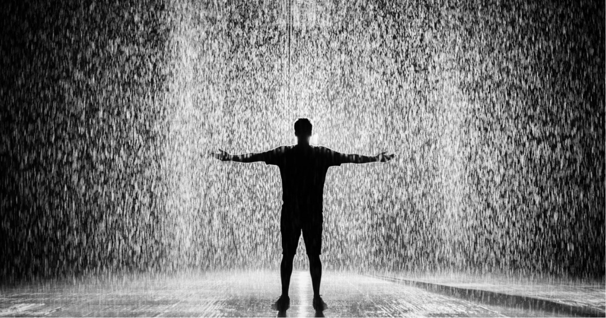 Seen Any Rain Yet, title image of a person standing with arms outstretched in the pouring rain